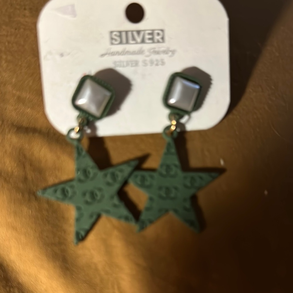 Silver star with logo dangling earrings